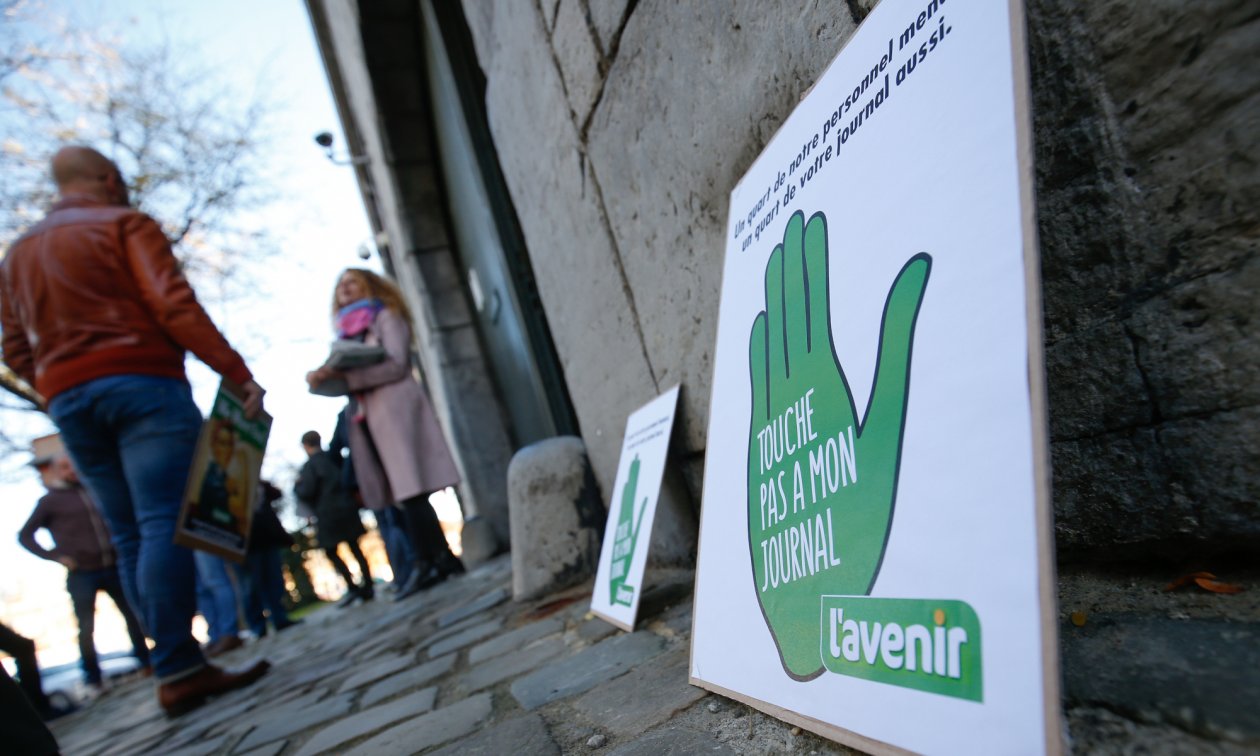 “Elinizi gazetemden çekin” – Günlük L’Avenir gazetesinin çalışanları devir planlarını protesto ederken (Kasım 2018).