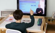 A boy takes part in a class broadcast by Turkish state television. (© picture-alliance/dpa)