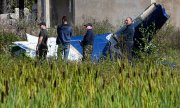 Inspectors amid the wreckage of the private jet in which Prigozhin is now thought to have been travelling on August 24. (© picture alliance / ASSOCIATED PRESS / Alexander Zemlianichenko)