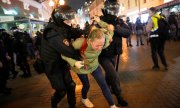 Polis, 21 Eylül 2022'de Moskova'da bir kadın göstericiyi gözaltına alıyor. (© picture alliance / ASSOCIATED PRESS / Alexander Zemlianichenko)