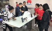 Customers at a Huawei store in Beijing. (© picture-alliance/dpa)