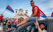 Opposition supporters celebrate on election night in front of the Serbian Orthodox Cathedral of the Resurrection of Christ in Podgorica. (© picture-alliance/dpa)