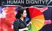 Женщина в Дублине на фоне плаката о недопущении абортов. (© picture-alliance/dpa)